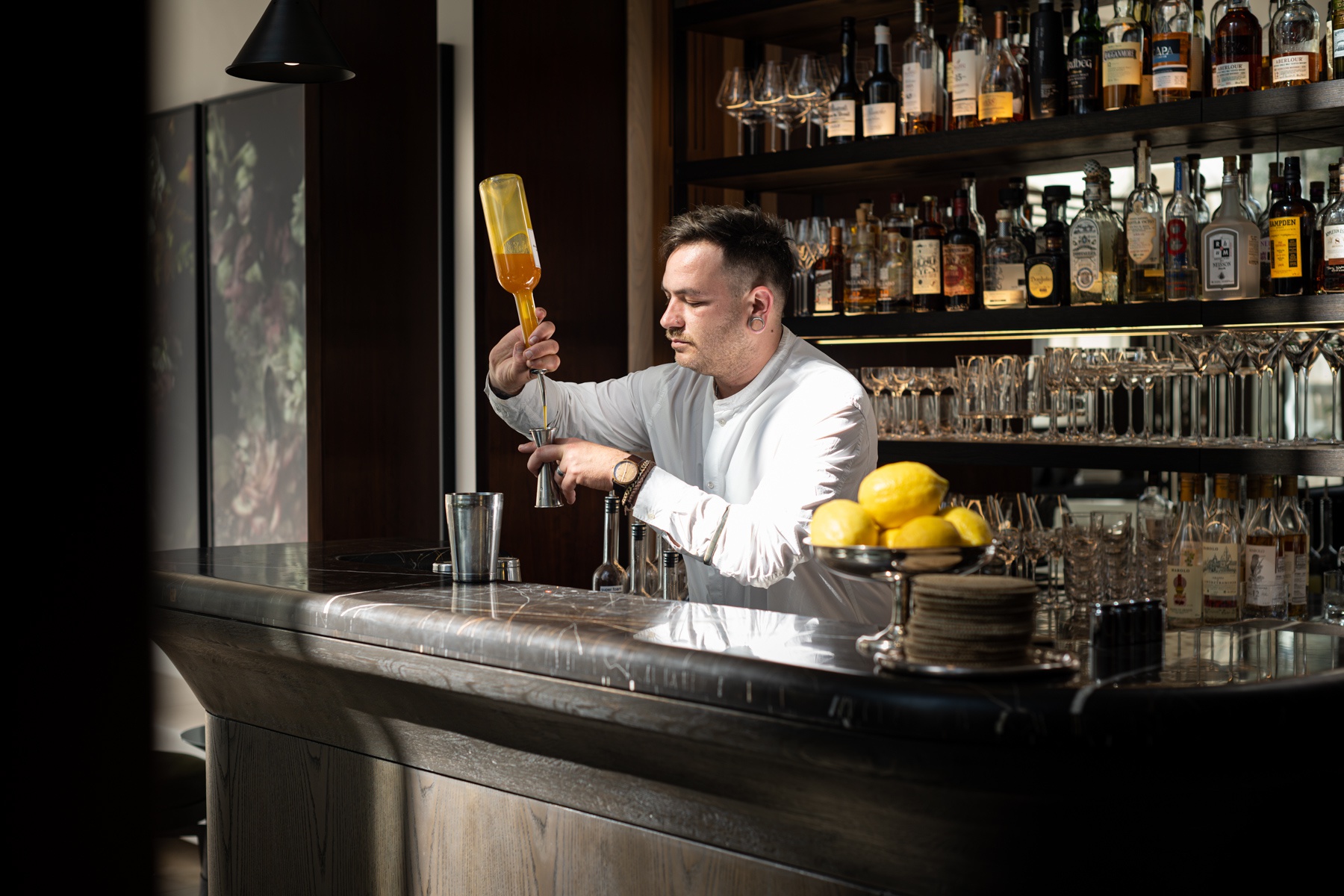 In this picture: Bartender Orel Levy at work behind the bar, R48 Hotel, Tel Aviv, Travel +Leisure.