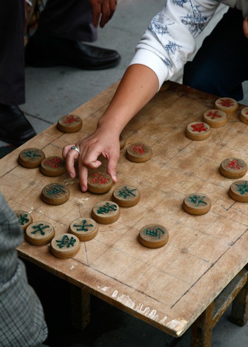 Two men playing Chinese Chess in the street. Beijing, China.. Asia, Beijing, China, Chinese, East, Far, Peking, asian, board, chess, city, close up, close-up,. China, Beijing